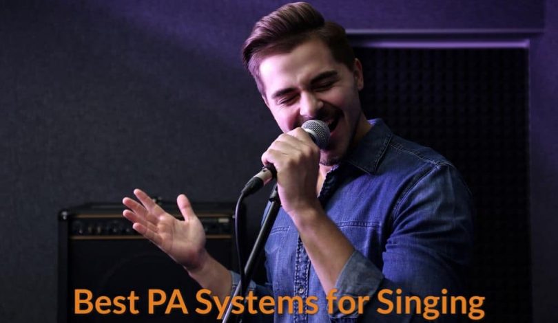A singer is using PA system speaker to amplify his singing voice.